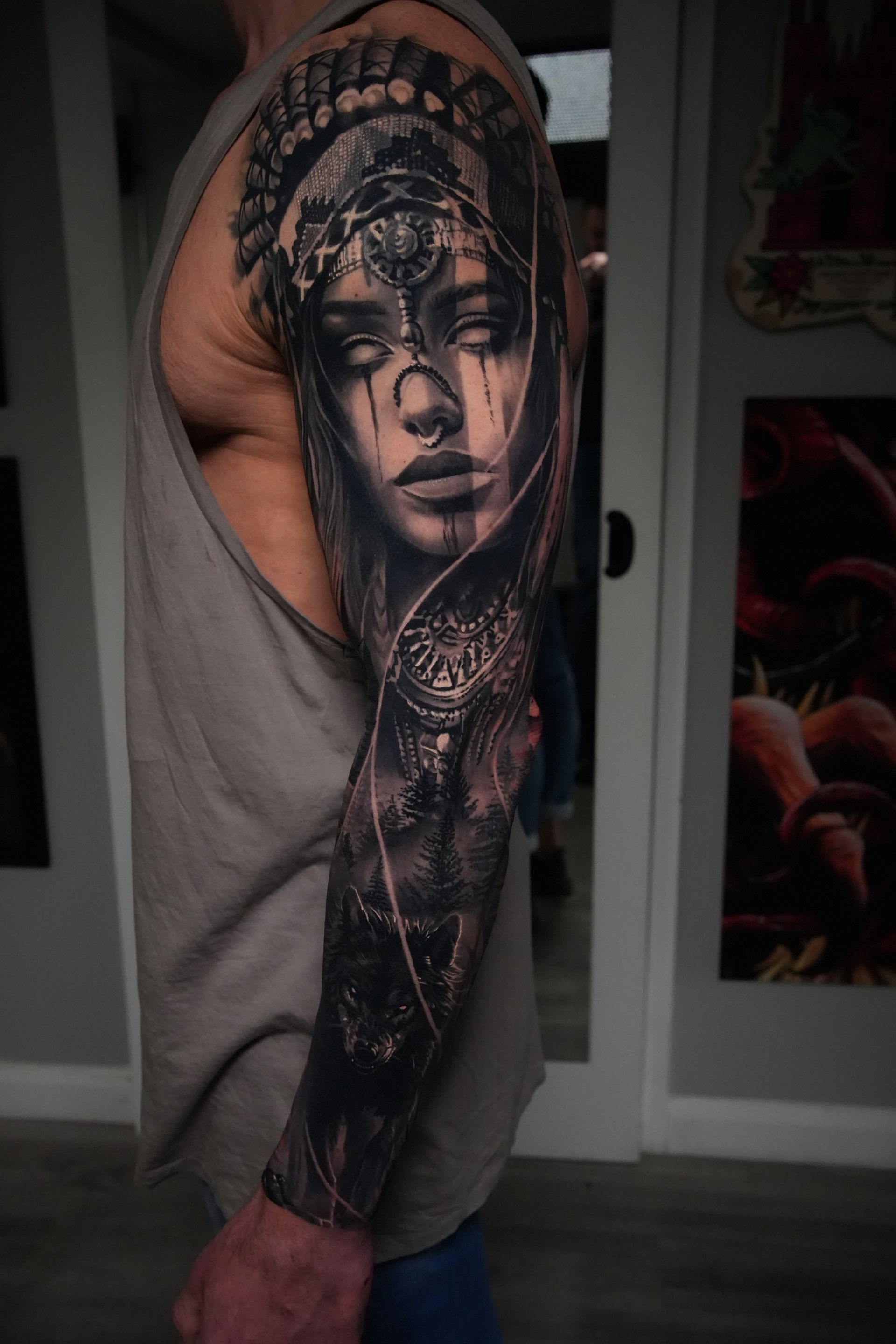A man has a tattoo of a woman 's face on his arm.